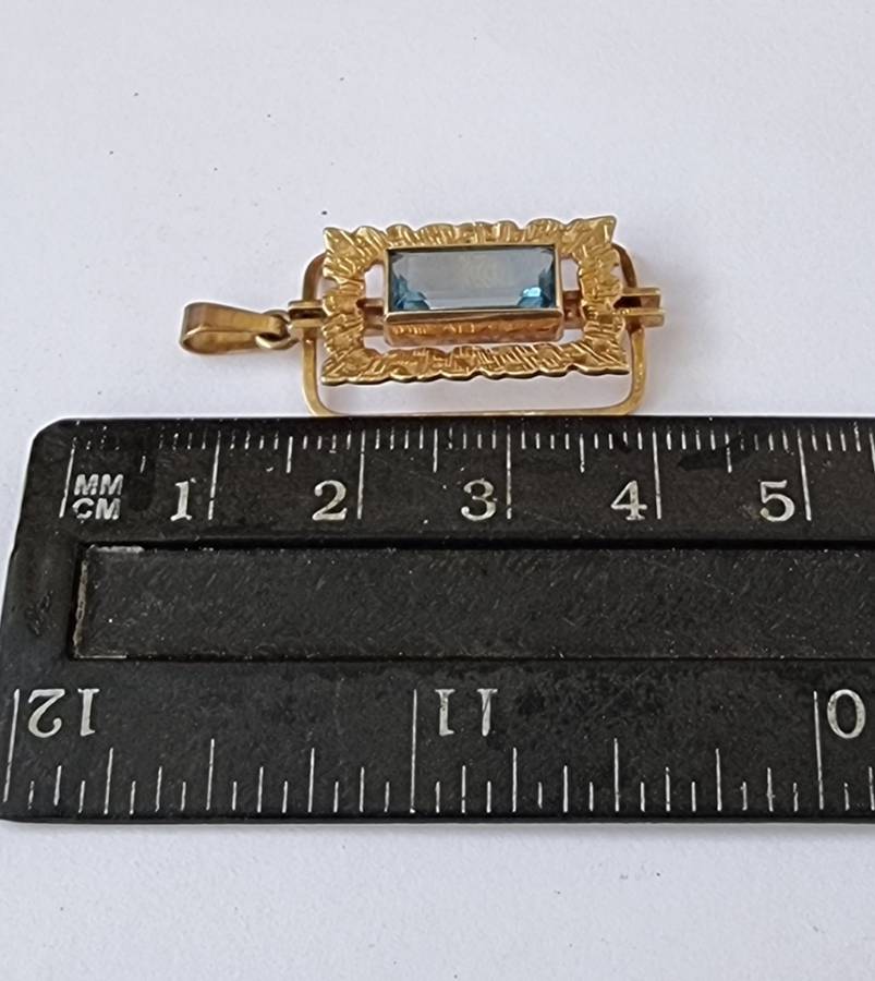 `ELECTRICK BLUE TOPAZ`  Set in a 9CT Yellow Gold Pendant (Genuine Gold)