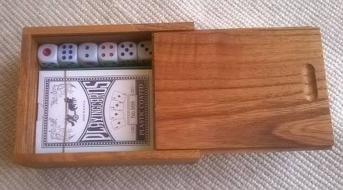wooden box with playing cards and dice