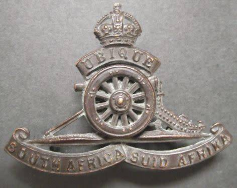 SOUTH AFRICA ARTILLERY CAP BADGE WITH TURNING WHEEL - LUGS INTACT