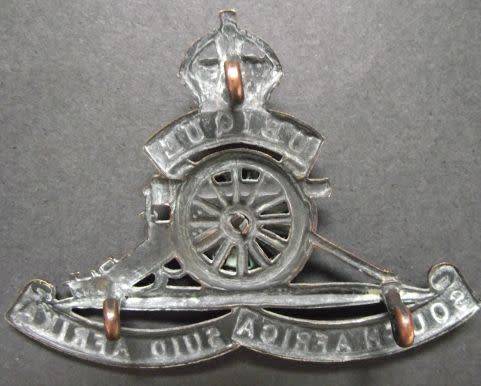 SOUTH AFRICA ARTILLERY CAP BADGE WITH TURNING WHEEL - LUGS INTACT