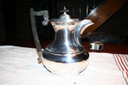 George VI silver plate rectangular hot water jug with plain bulbous body and ebonised handle,Viners