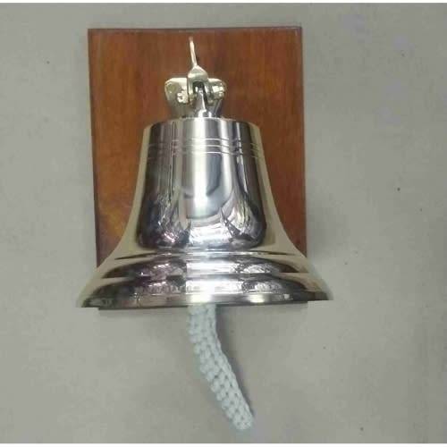 Brass bell 25cm on wood backing.
