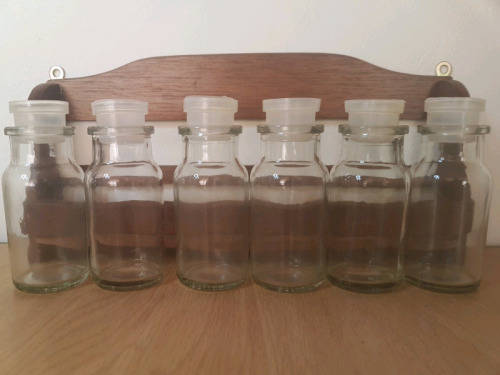 Spice rack with glass bottles