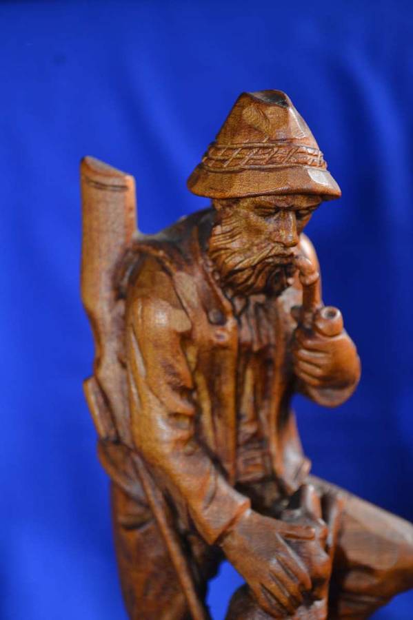 Wooden Carving of a Hunter with his Dog