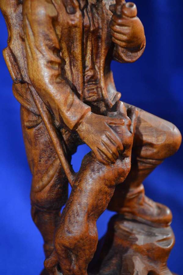Wooden Carving of a Hunter with his Dog