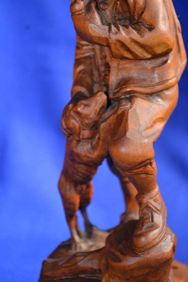 Wooden Carving of a Hunter with his Dog