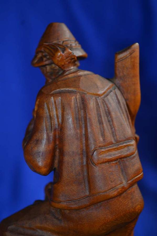 Wooden Carving of a Hunter with his Dog