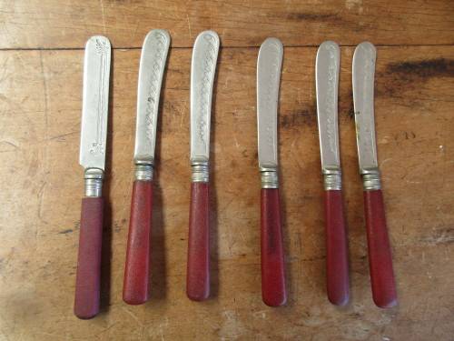 6 Red resin handled butter knives