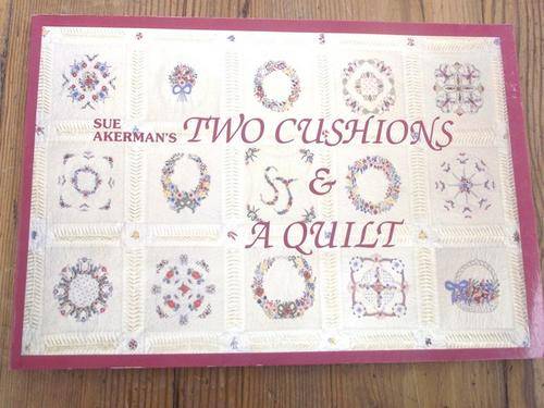 TWO CUSHIONS AND A QUILT