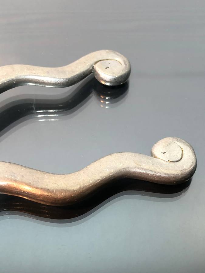 A set of Carol Boyes Wave Salad Spoons and a Larger Serving Spoon