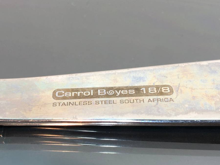 A set of Carol Boyes Wave Salad Spoons and a Larger Serving Spoon