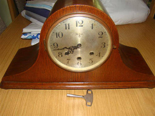 The oak wood case is beautifully crafted with a lovely patina and the grain of the wood shows throug