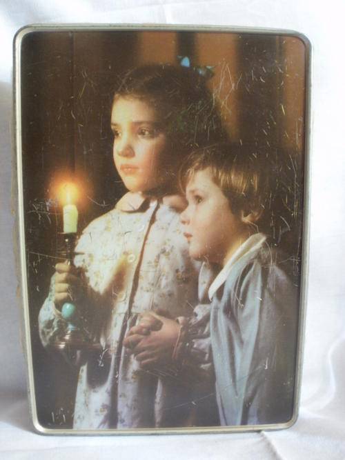 LOVELY TIN OF A BOY & GIRL HOLDING A CANDLE