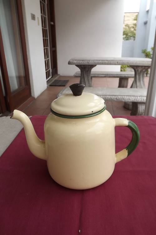 Vintage cream colour enamel teapot  and lid with green rim.Inside show usage.
