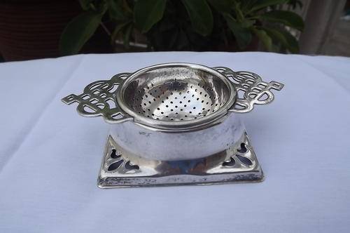 Antique tea strainer on stand EPNS - made in England