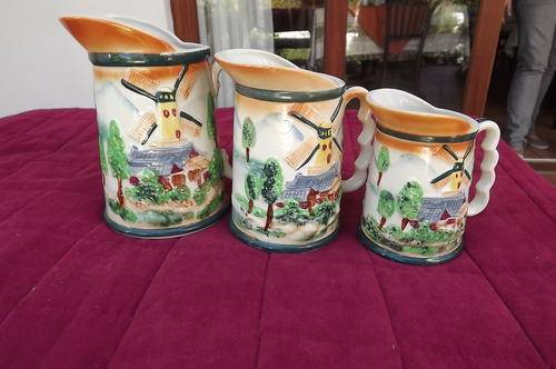 Set of 3 different size porcelain mugs/jugs in windmill design.Good condition