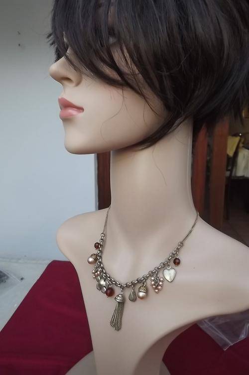 Gold colour choker type necklace with different charms.Good condition