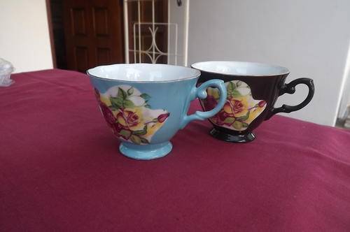 Two by loose thin porcelain cups.1Blue & 1Black.Both with same floral design.Good condition