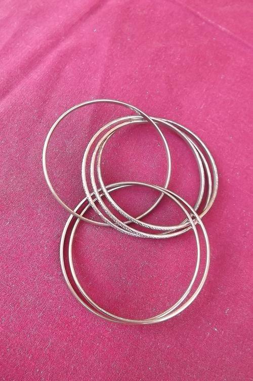 Entangled set of metal bangles 7.2 cm diameter.Copper & brass