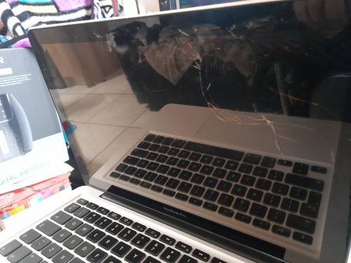 **MONTH END MADNESS*APPLE MAC BOOK PRO*NO CHARER NOT SURE SPECS*CRACKED SCREEN**