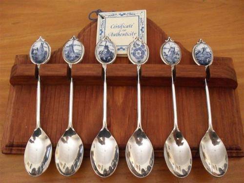 6 DELFT TEASPOONS ON A WOODEN DISPLAY RACK