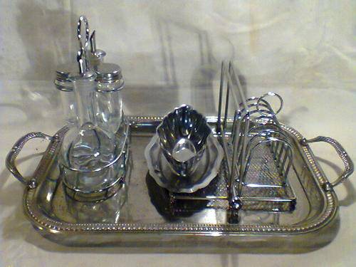A Vintage Lot of Items, Tray with Cruet set, Toast Rack, Gravy Boat,Napkin Holder.All used condition
