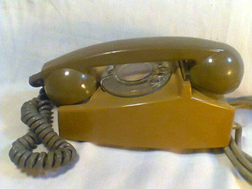 A Old Vintage Telephone in two tone Green with the old style plug. In fair condition.
