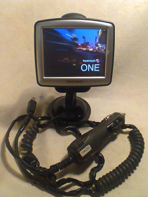 A Tom Tom One with charger + suction mounting Stand. In second hand and in working Condition.