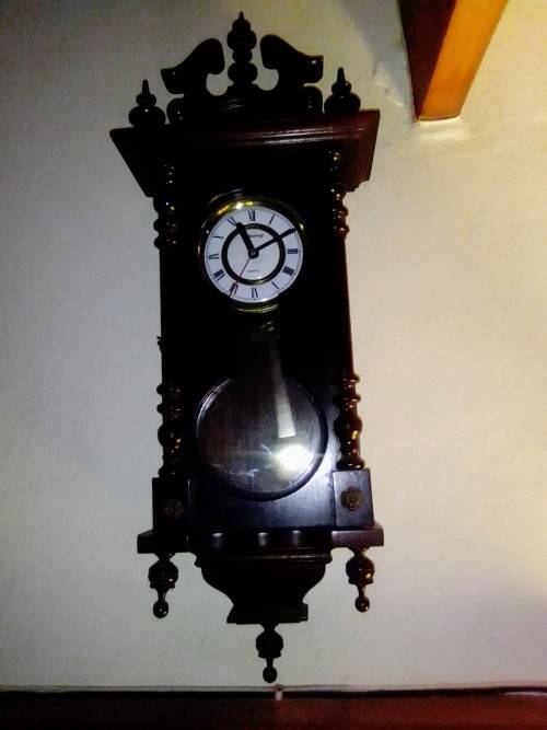 A clean dark wood working Quarts `Blessing` Wall Clock. In good condition.