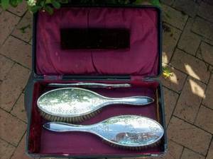 A VINTAGE SET OF HALL MARKED SILVER BACKED HAIR BRUSHES
