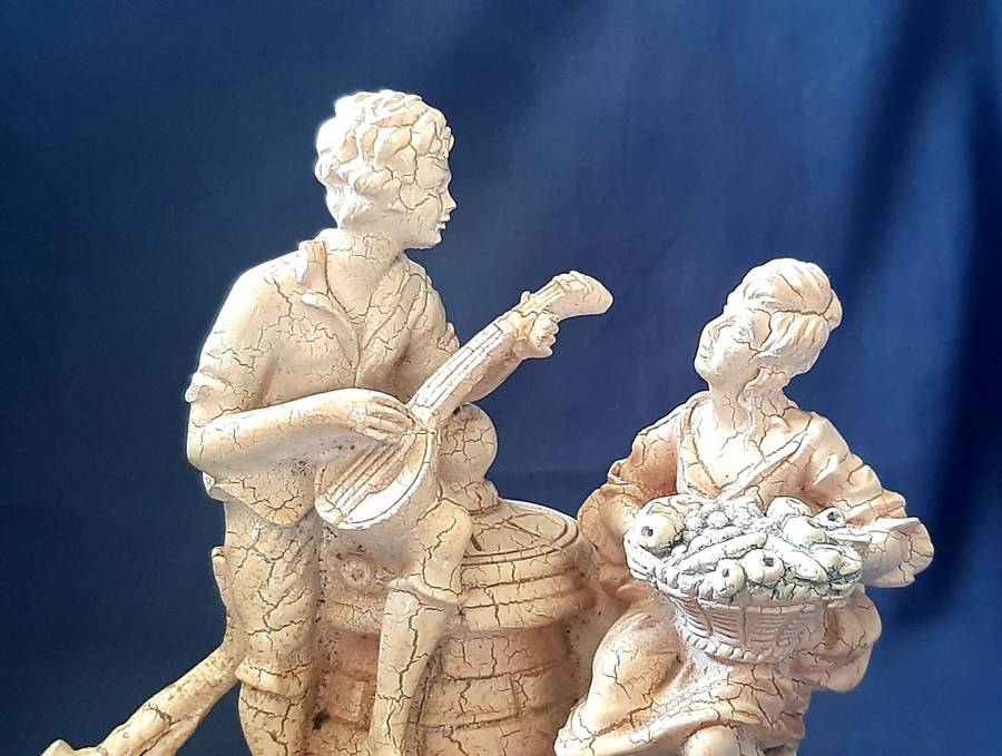 VINTAGE STATUE OF MAN SERENADING A WOMAN