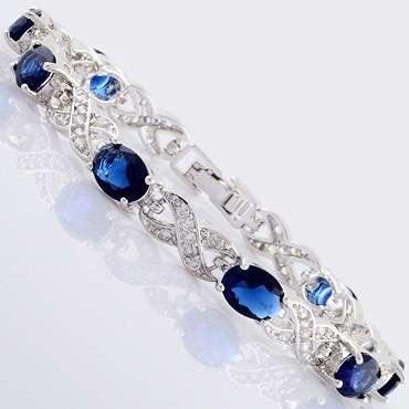 **STUNNING WHITE GOLD OVAL CUT BLUE SAPPHIRE TENNIS BRACELET **