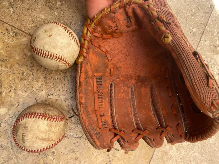 Vintage leather flame baseball  base ball mitt glove and a pair of old Wilson ball balls