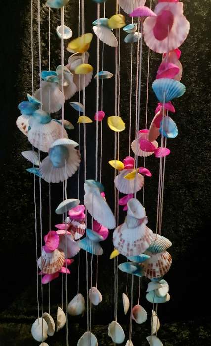 Fun and flirty. Pink, blue and yellow shell windchime