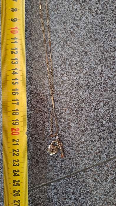 Gold toned necklace with heart and key