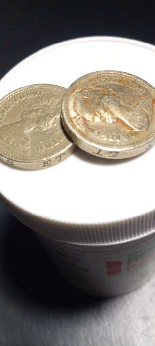 1983 British one pound coin.ERROR : See lettering upside down on the Rim of the coin