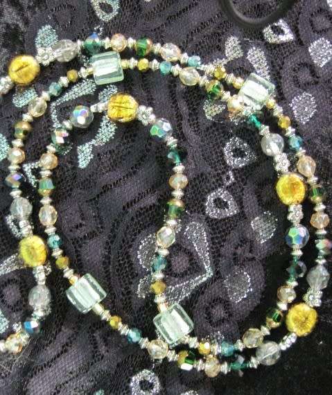 Beautiful long beaded necklace in greens and golds. LN4