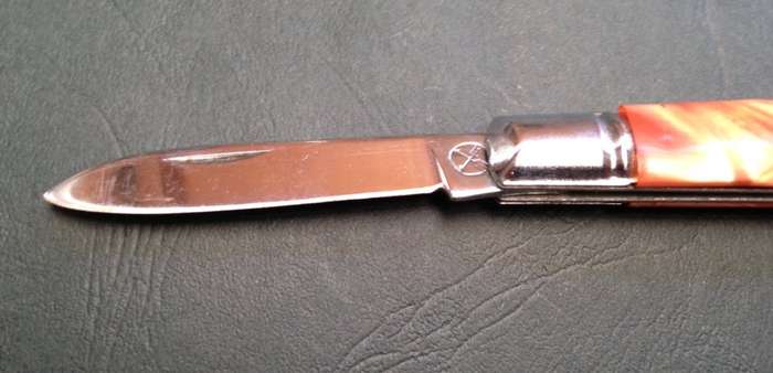 Pocket knife, crossed arrows mark.