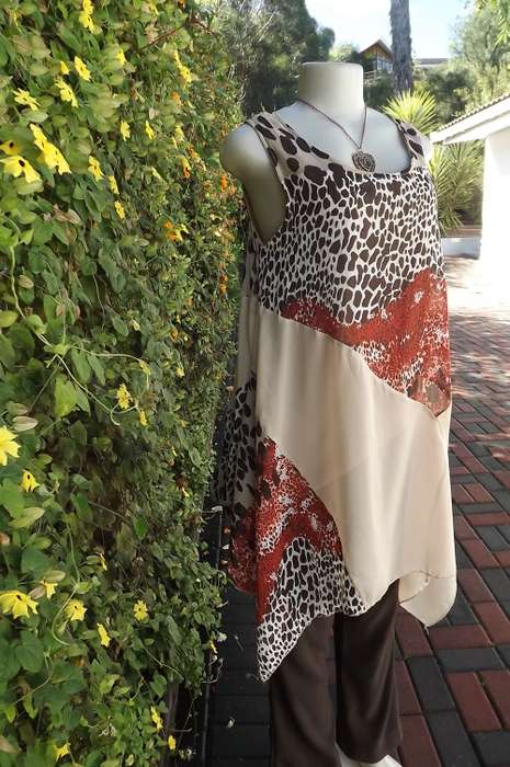 Beautiful long top with high/low seam.Size 34/10 by Pierre Mailhe Paris.In animal print and beige