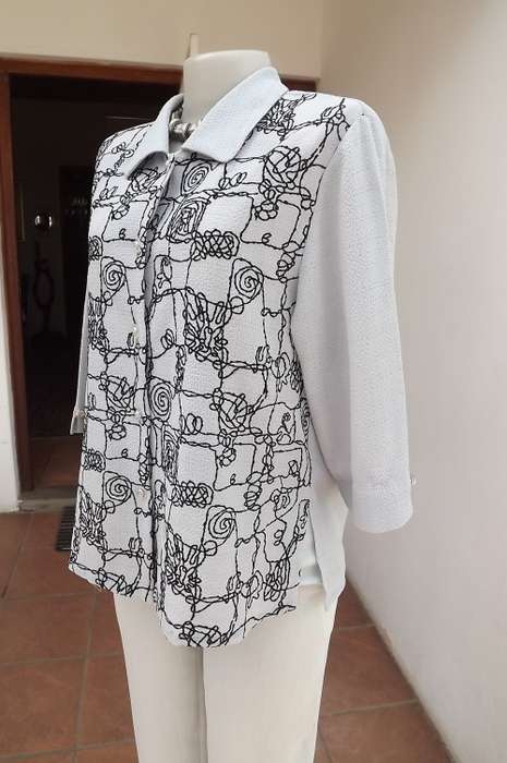 Wonderful silver grey top/short sleeve jacket size 36/12.Black graphic embroidery on front.