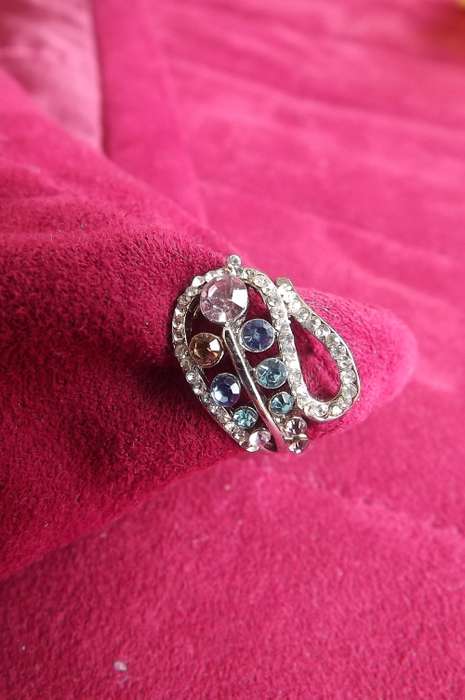 Dainty silver toned ring with lots of colourful stones.Pretty design.Rhodium plated .Size 7. New