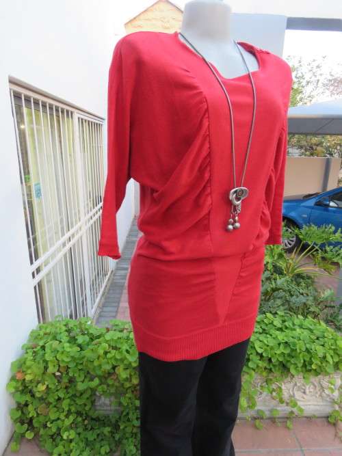 Pretty long red knitted top by RT in 34 with dolman sleeves.In acrylic knit .