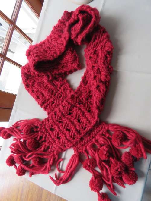 Warm and cosy red scarf knitted in thick bulky wool.Length 2.2 m width 17 cm.New condition.