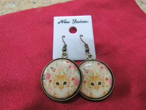 Pair of pierced drop earrings with kitten front in round design with brass backing.New.