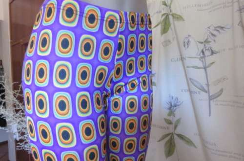 Eyecatching bootlegged polyester stretch pants size 34 to 36 in purple with orange, black+turquoise