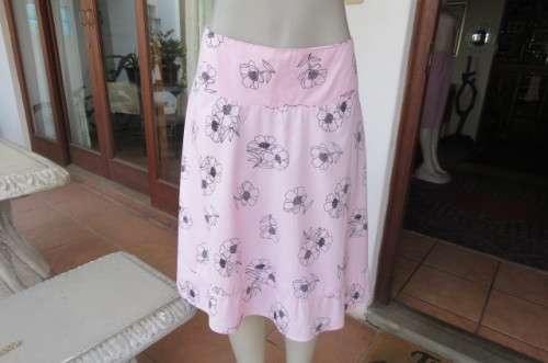 Lovely coral colour wide A-line skirt with black flowers.Yoked waist size 34/10 by `Legit`. As new.