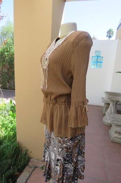 Fab light brown peplum style top in pattern creased 100% wash and wear polyester fabric.Size 36/12