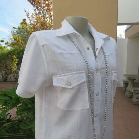 Casual white short sleeve top closing with press buttons. Size 36/12 by RT. Cowboy yokes.As new