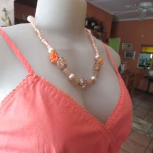 Sexy apricot colour strappy top with empire front and drawstring and crossover front. Size 38/14.