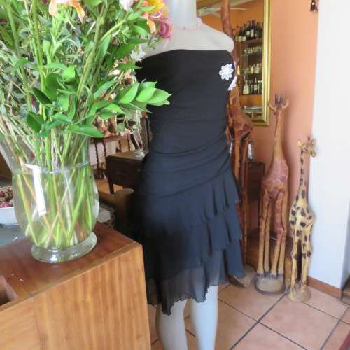 Little black dress with frilled bottom and ruched strapless top. Size 34/10 By `Jin Taiyang`. As new